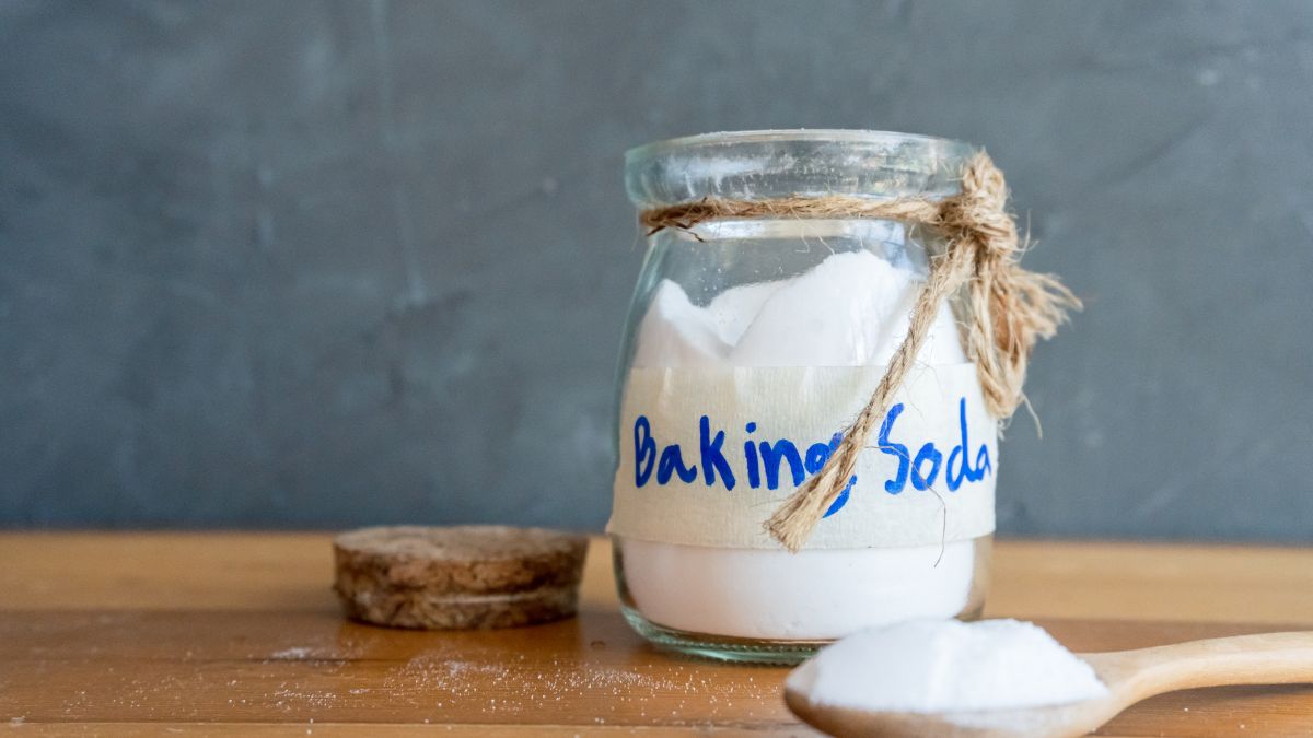 Jar of baking soda styled simply on a kitchen counter.