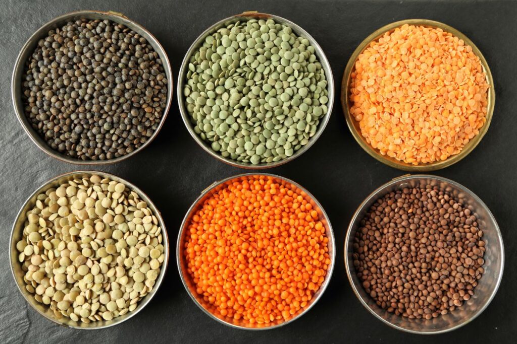 Different types of lentils in bowls.
