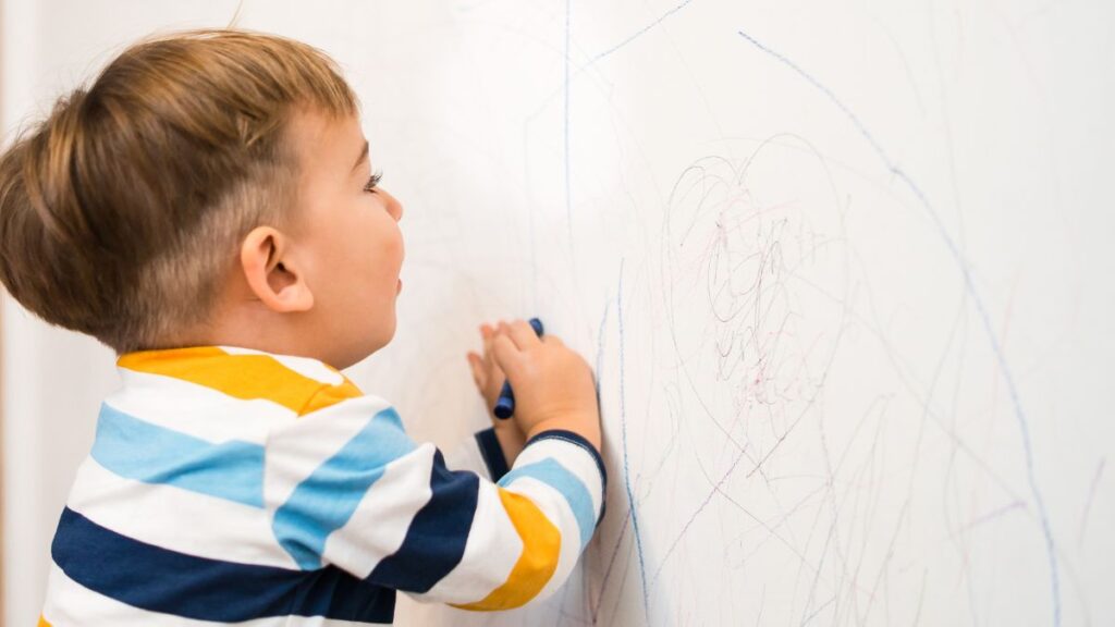 Cleaning crayon marks from wall using baking soda paste.