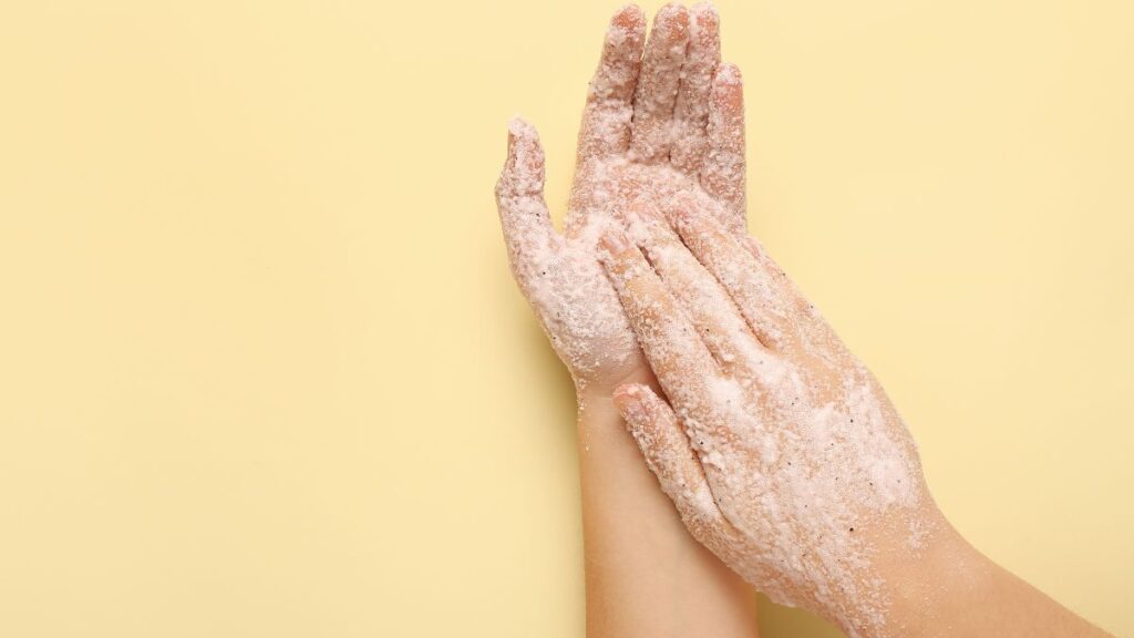 Gentle hand exfoliation with homemade baking soda scrub.