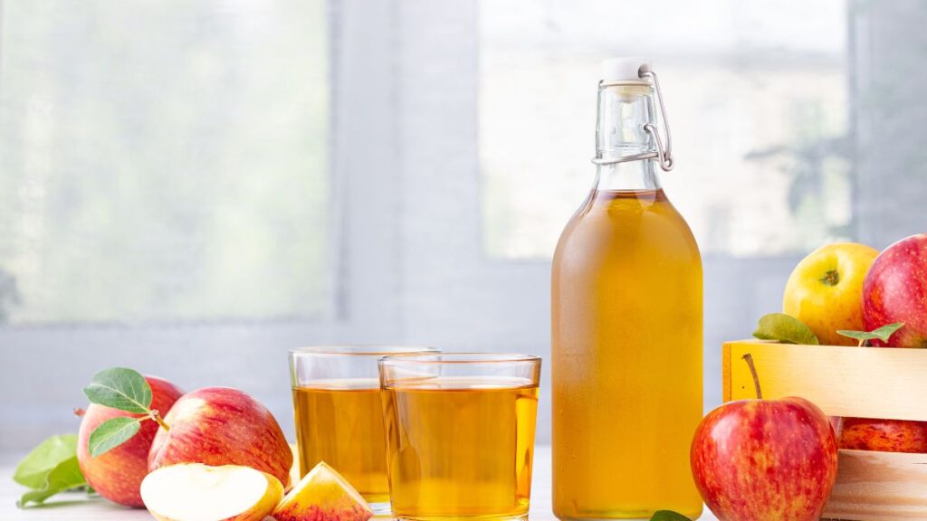 Glass of apple cider vinegar detox drink with lemon and honey.