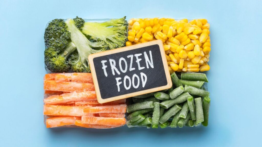 Frozen broccoli, corn, carrots, and green beans with a frozen food sign.