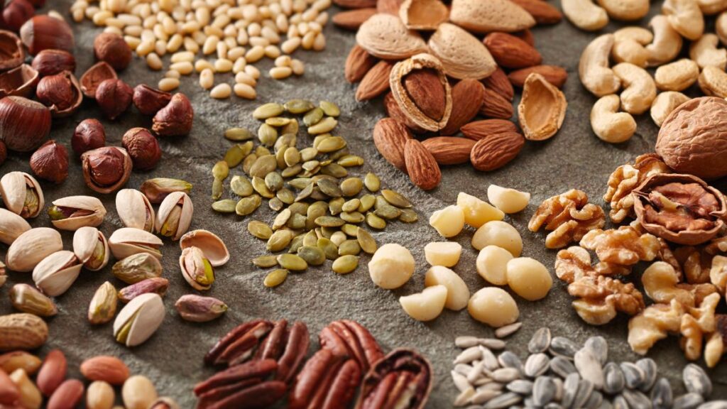 Various seeds and nuts on a board.
