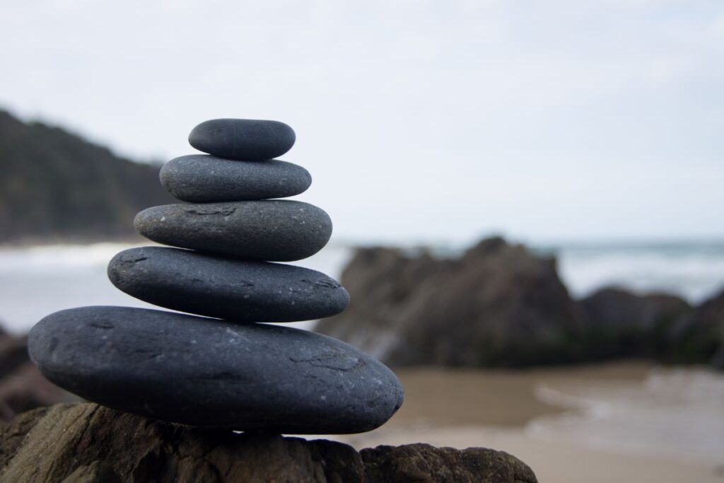 Balanced stack of grey stones symbolizing calm and neutrality.