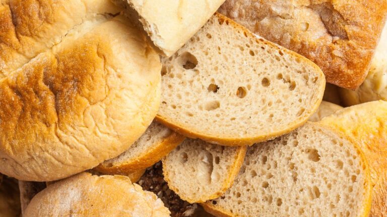 Close-up of assorted sliced bread loaves showing crusty and soft textures.