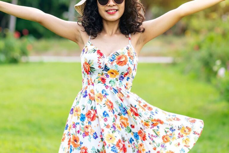 Girl in a garden wearing a floral outfit.