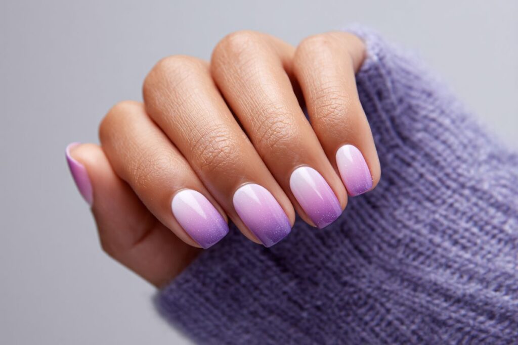 Lavender ombré winter nails with soft shimmer and short shape.