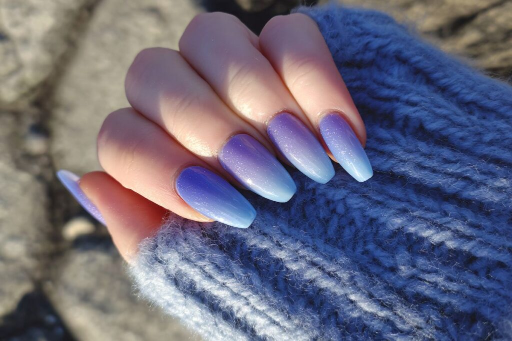 Icy blue ombré winter nails with subtle sparkle finish