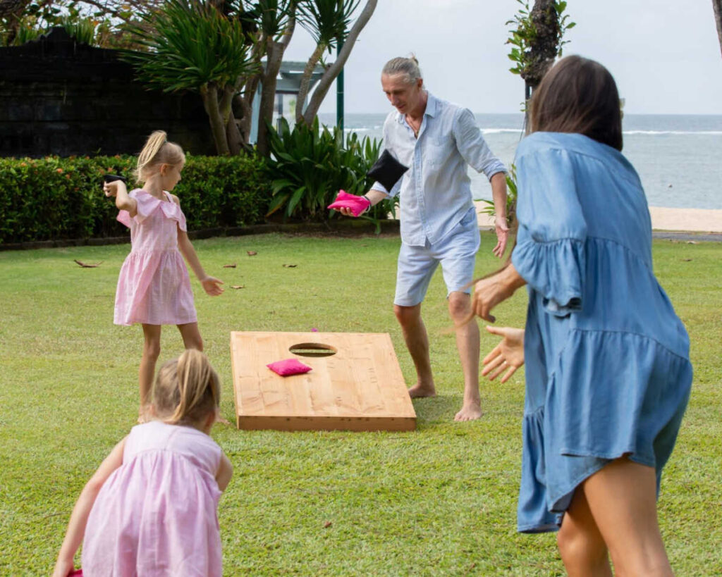 A family playing outdoor games in the backyard.