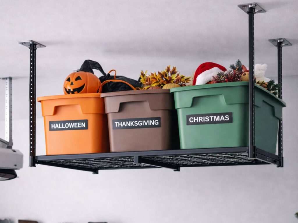 Overhead garage rack storing labeled holiday storage bins