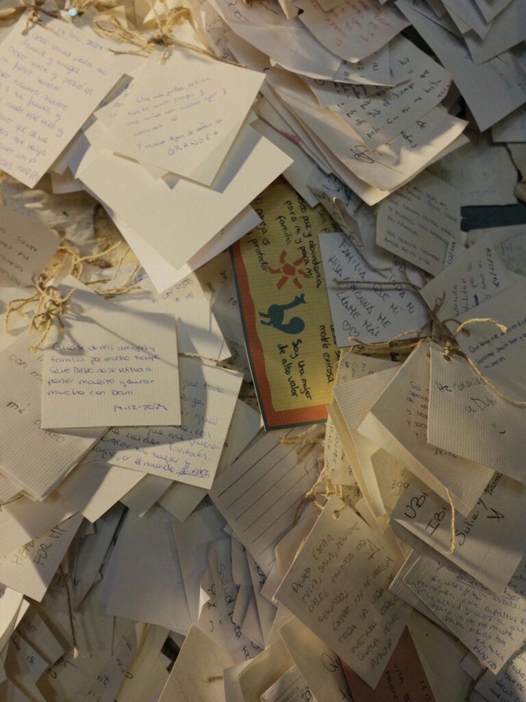 Stack of handwritten notes and letters tied together with string.