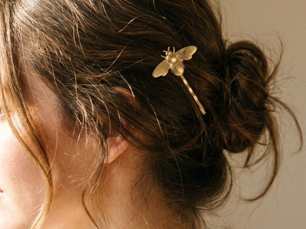 Hair styled with bee hair clip in soft natural light