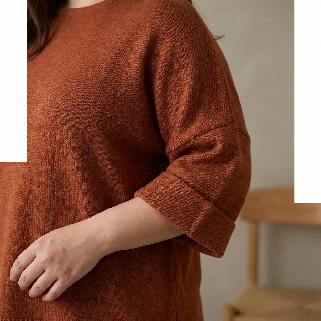 Close-up of a three-quarter sleeve with a defined cuff on a fitted top.