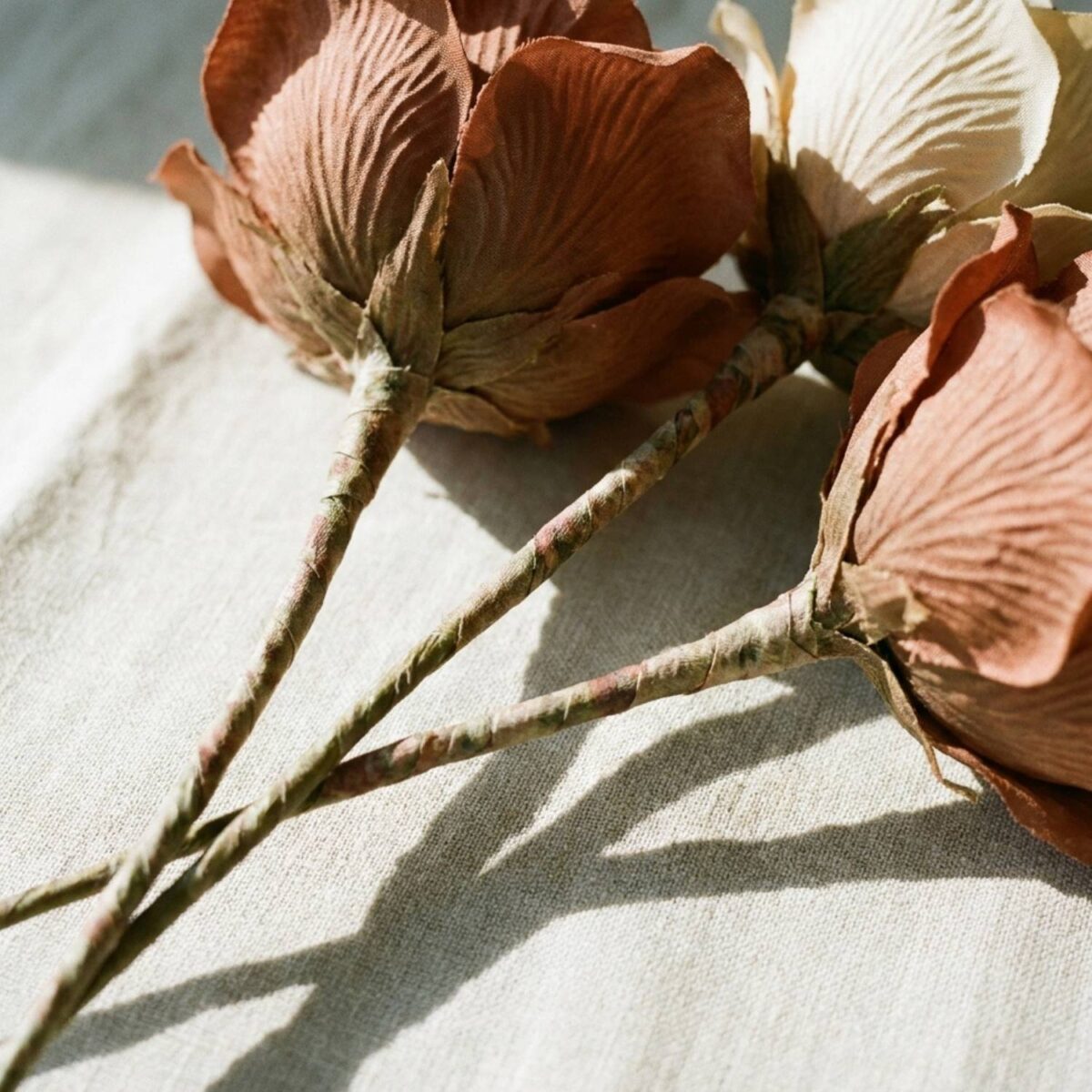 Close-up of faux flower stems showing wire cores and textured petals.