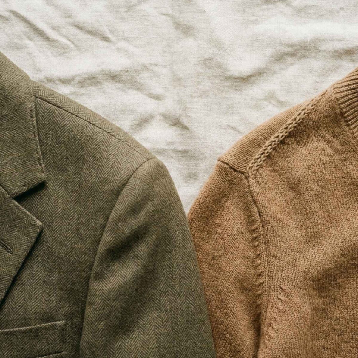 Close-up of an olive green tailored blazer and a camel brown knit sweater displayed side by side.